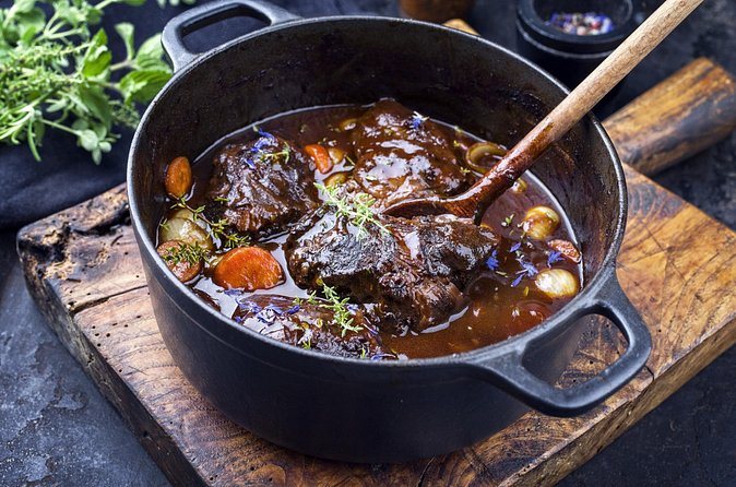 Boeuf bourguignon in a cast-iron pot, the ladle still in it