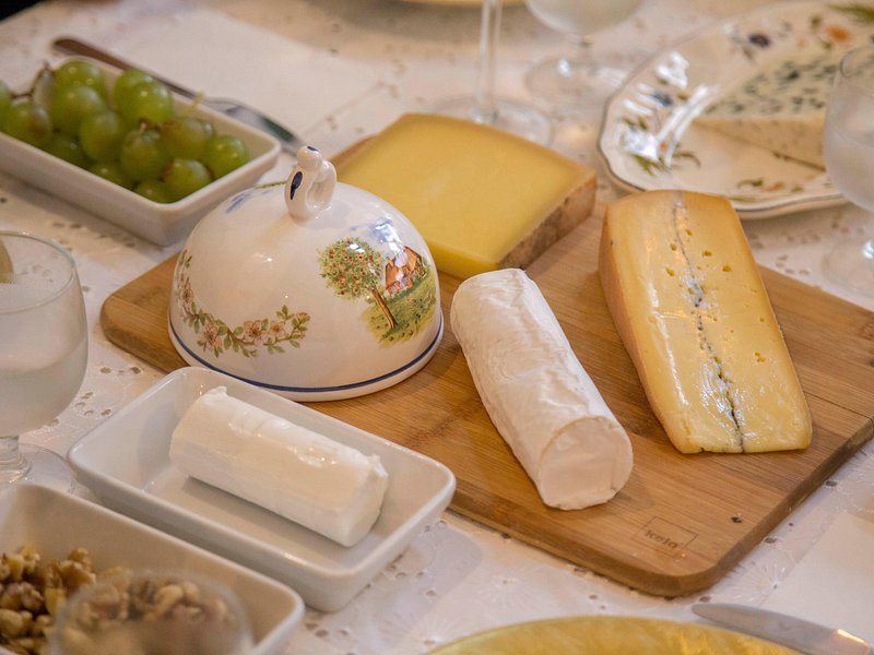 Wrapped French cheeses laid out on a market counter