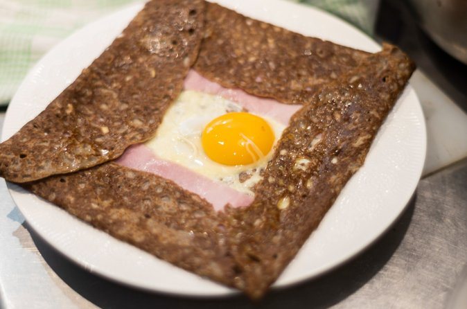 A buckwheat galette folded around ham and a whole egg