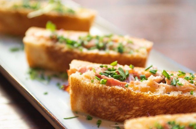 Open tartines on toasted baguette, topped and cut for a tasting
